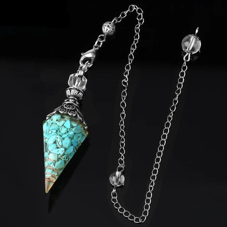 Turquoise stone pendant with chain on a black background