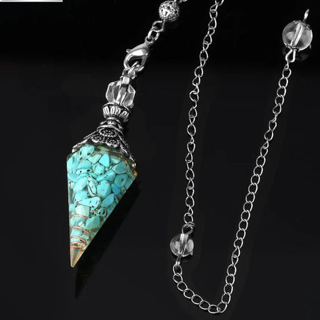 Turquoise stone pendant with chain on a black background