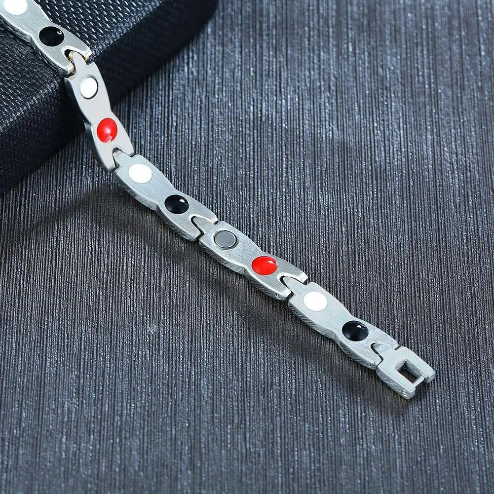Metal bracelet with colored beads on a textured dark surface