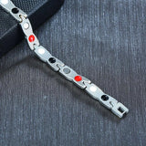 Metal bracelet with colored beads on a textured dark surface