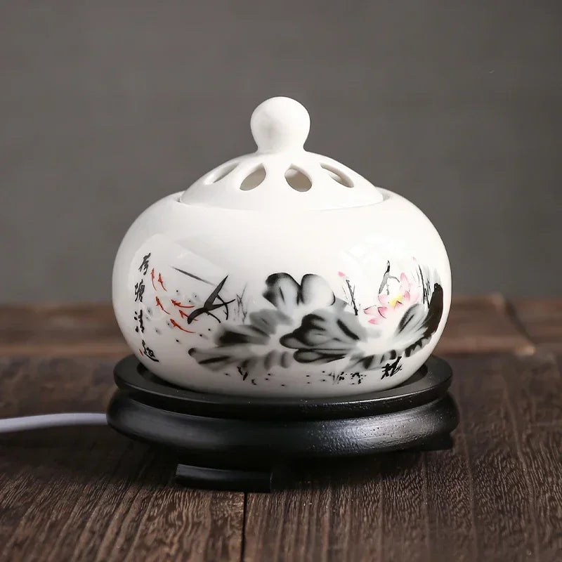 Ceramic aroma lamp with floral design on a wooden surface