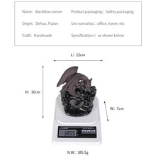 Black dragon sculpture on a digital scale with dimensions and weight displayed.
