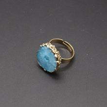 Gold ring with a blue stone on a dark gray background