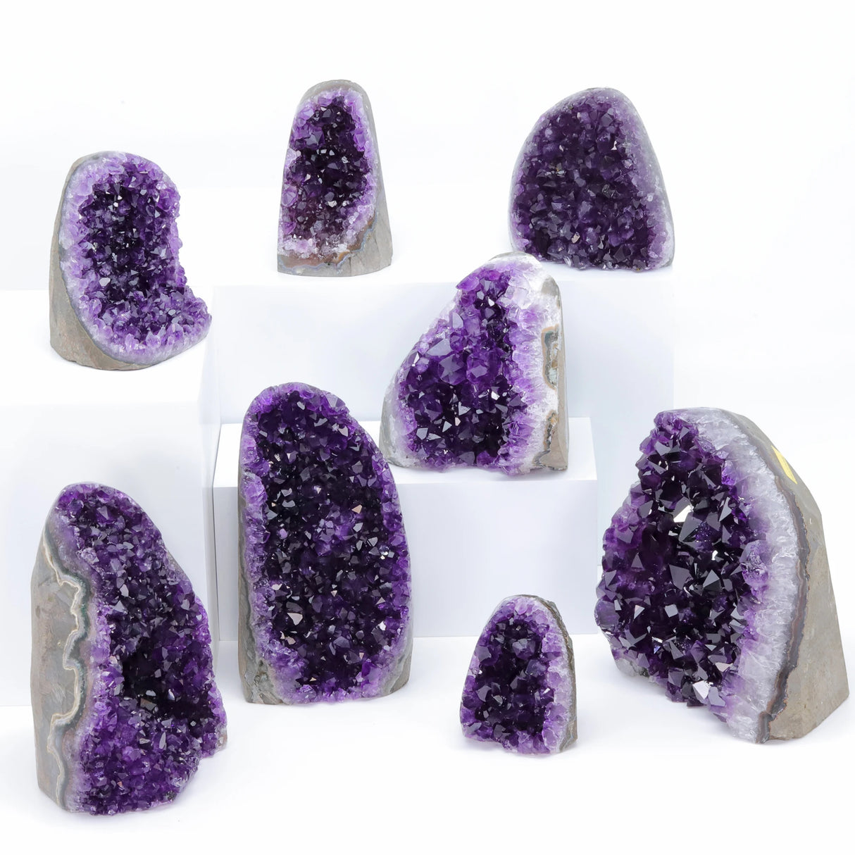 Collection of purple crystal geodes on a white background