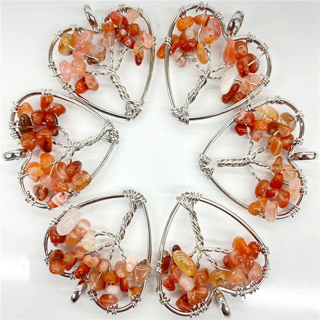 Set of heart-shaped stone pendants with silver wire frames on a white background