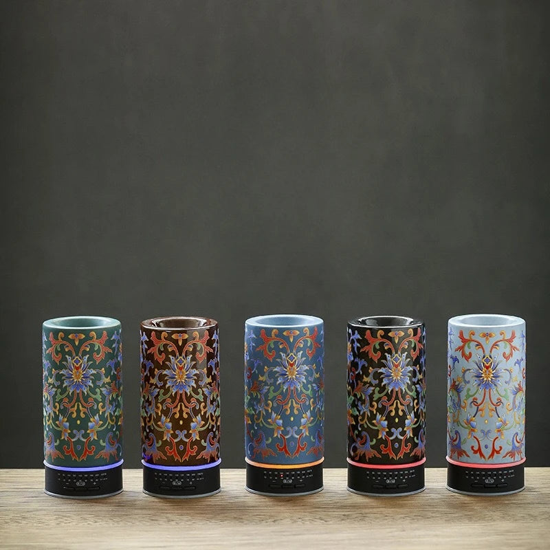Five cylindrical decorative items with intricate patterns on a wooden surface and dark background