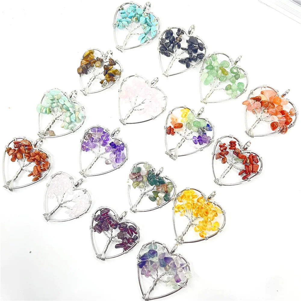 Heart-shaped pendants with embedded stones and leaves on a white background