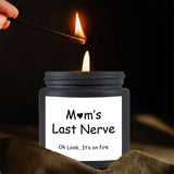 Candle labeled 'Mom's Last Nerve' being lit with a match against a dark background