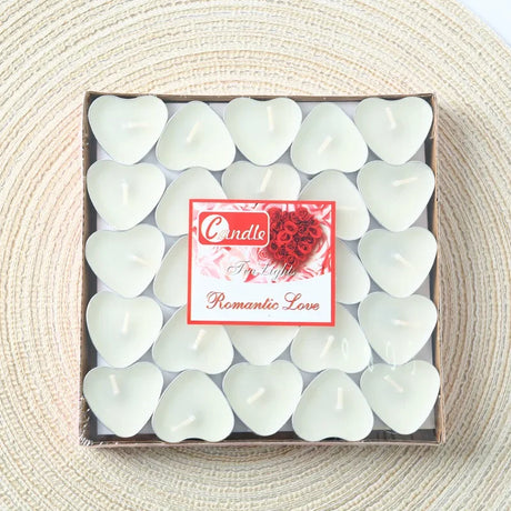Box of heart-shaped candles with a decorative label on a textured surface
