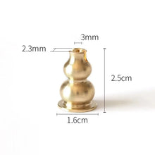 Brass candle holder with measurements on a white background