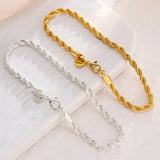 Gold and silver chain necklaces on a light background