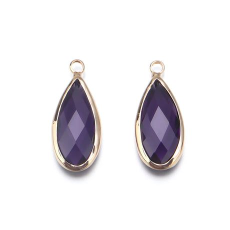 Two purple teardrop-shaped pendants with gold frames on a white background