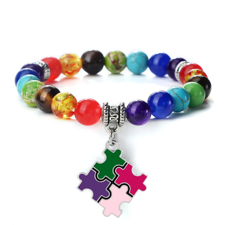 Colorful beaded bracelet with a puzzle piece charm on a white background