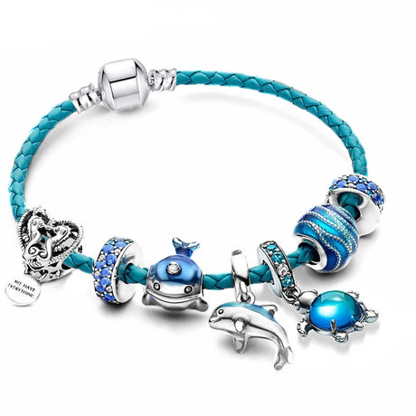 Blue braided bracelet with various charms on a white background