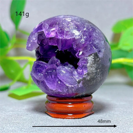 Amethyst crystal sphere on a stand with measurements and weight label