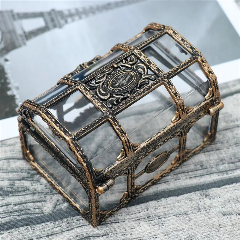 Decorative glass box with bronze frame on a textured surface