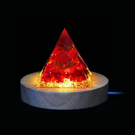 Pyramid-shaped light on a wooden base with a dark background