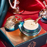 Cosmetic jar with gold lid on a decorative box against a red background