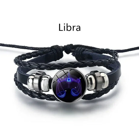 Black braided bracelet with silver accents and a Libra zodiac symbol on a white background