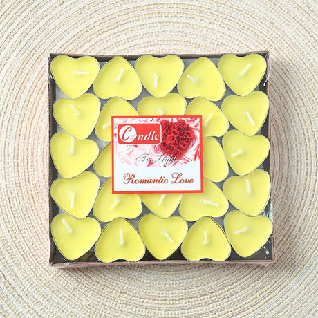 Box of heart-shaped candles with a romantic theme on a textured surface
