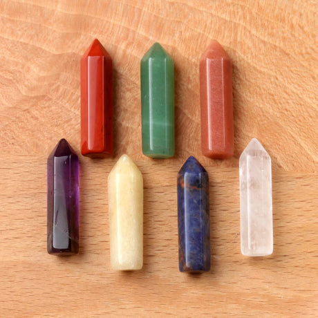 Set of colorful crystal points on a wooden surface