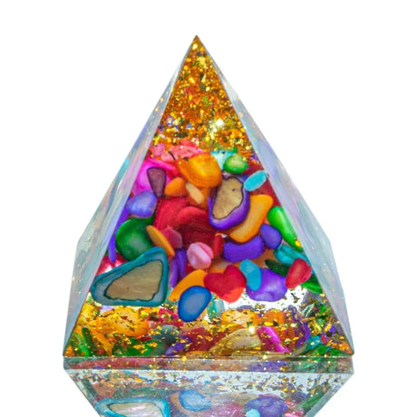 Triangular pyramid filled with colorful stones and glitter on a white background