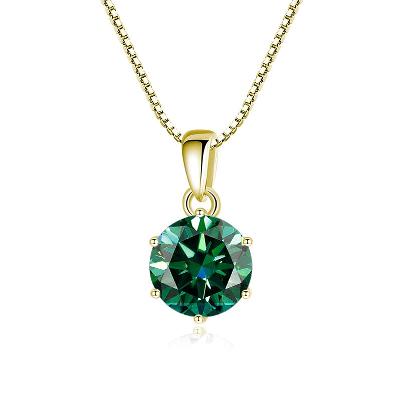 Gold pendant with a green gemstone on a white background