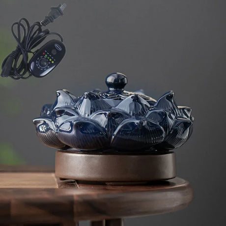 Blue ceramic incense burner on a wooden surface with a dark background