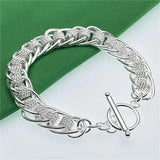 Silver bracelet on a green and white background