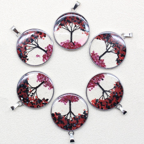 Set of six circular pendants with tree designs on a white background