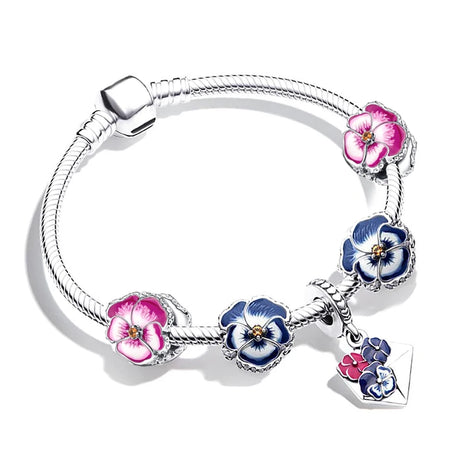 Silver bracelet with floral charms on a white background