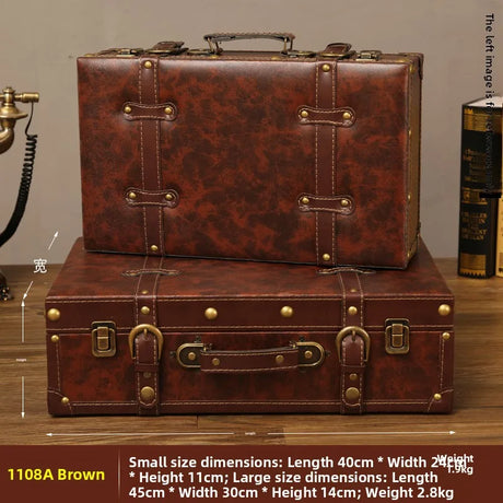 Two brown leather suitcases stacked on a wooden surface with dimensions and weight details.
