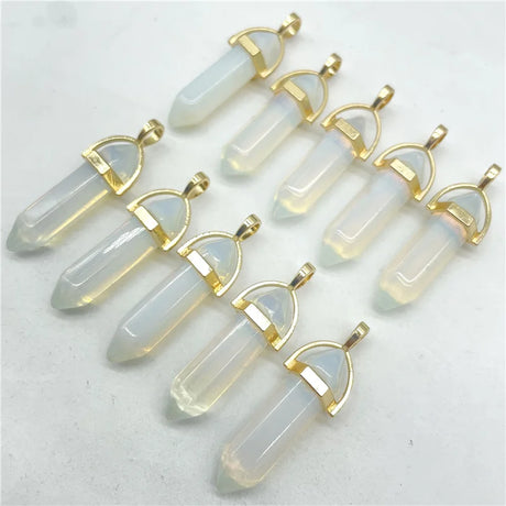 Set of crystal pendants with gold accents on a light gray background