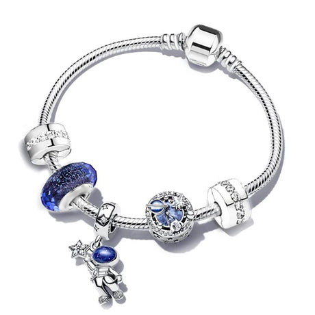 Silver bracelet with blue heart-shaped charm and star-shaped charm on a white background