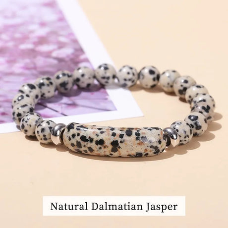 Natural Dalmatian Jasper bracelet on a light pink background