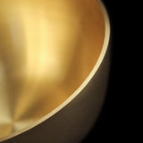Close-up of a gold metallic surface with a black background