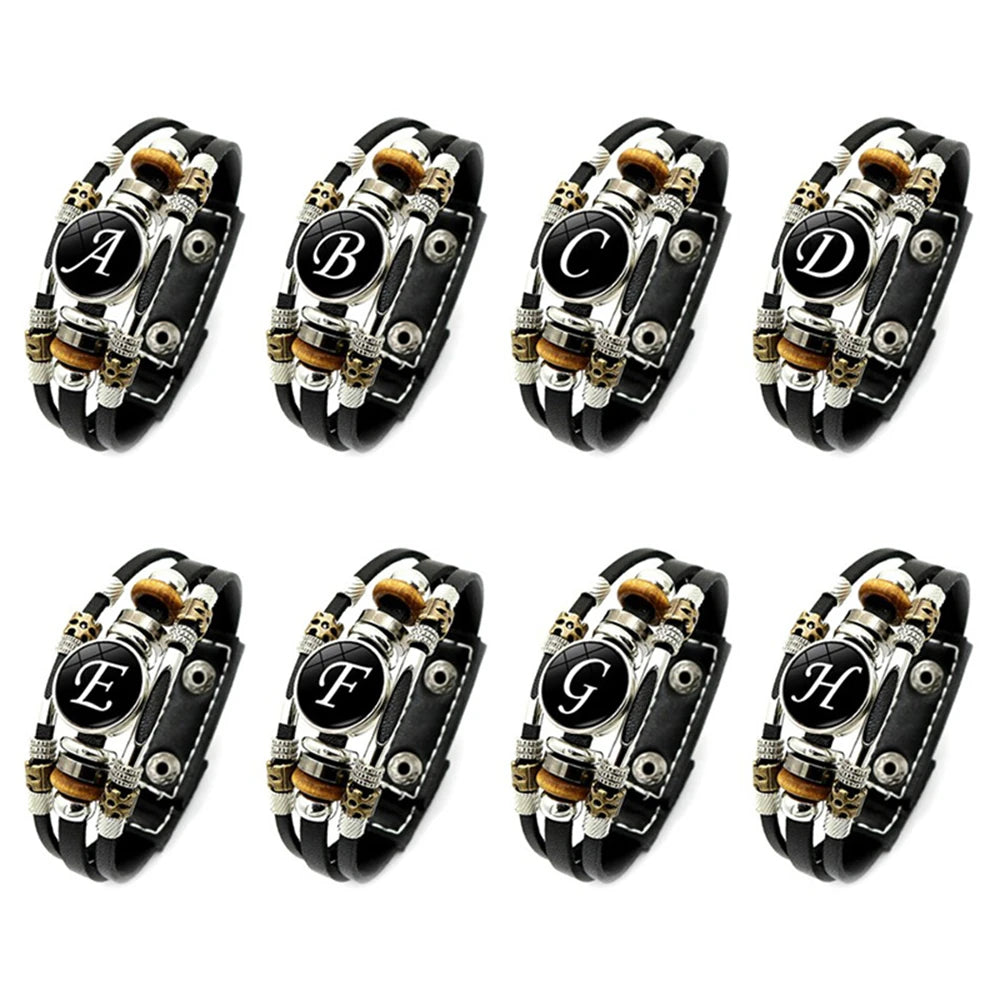 Set of eight black leather bracelets with letter symbols on a white background