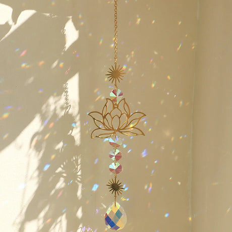 Decorative hanging ornament with lotus design and rainbow prism on a beige background