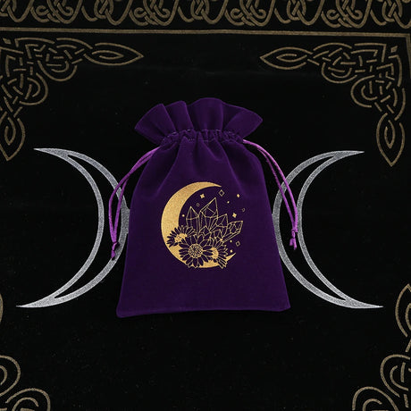 Purple drawstring bag with gold moon and crystal design on a black background with Celtic patterns