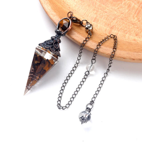 Necklace with a crystal pendant on a wooden surface