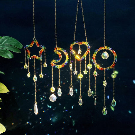Colorful hanging decorative items with star, moon, and heart shapes on a dark background.