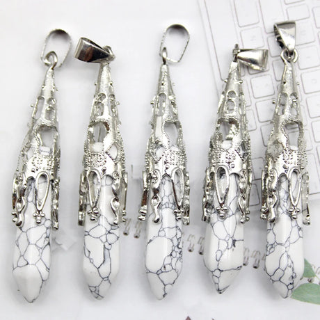 Set of silver and white marbled stone pendants on a white background