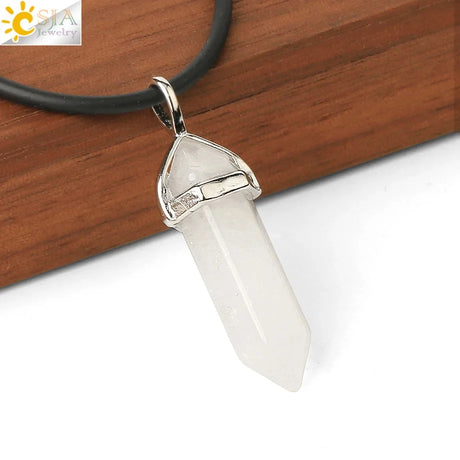 Crystal pendant on a white background with a wooden surface