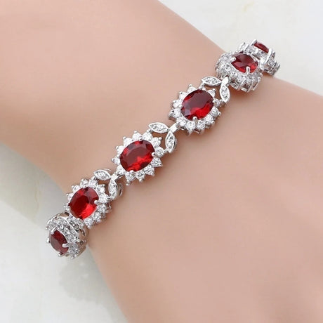 Silver bracelet with red gemstones on a mannequin wrist
