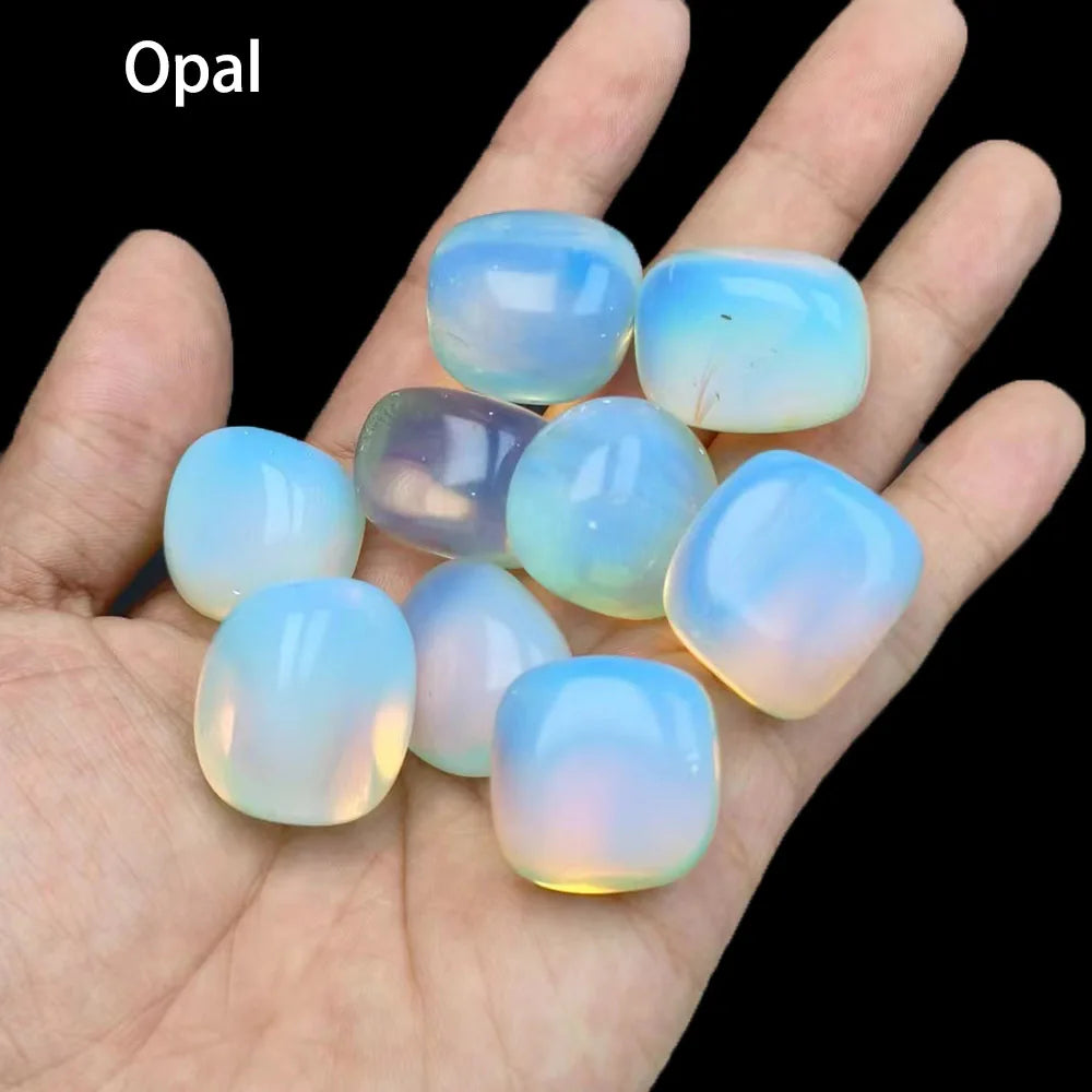 Opal stones on a hand with a black background