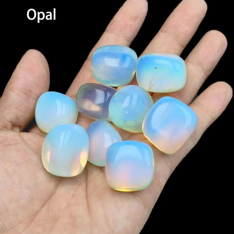 Opal stones on a hand with a black background