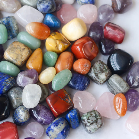 Assorted colorful gemstones on a white background