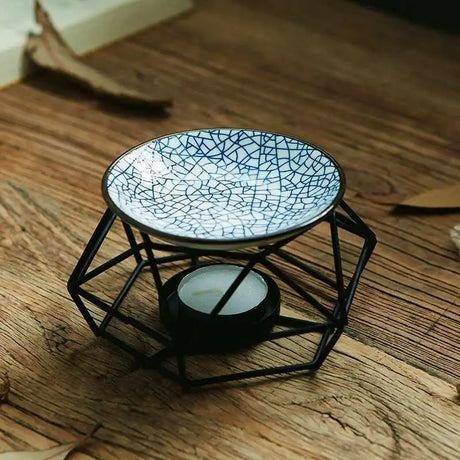 Ceramic dish with cracked glass design on a black metal stand on a wooden surface