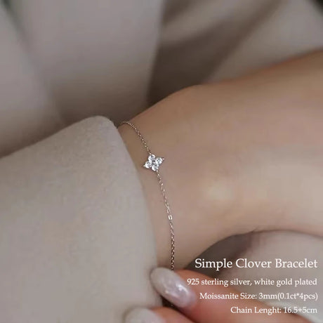 Silver bracelet with a clover design on a wrist, with text detailing the product information.