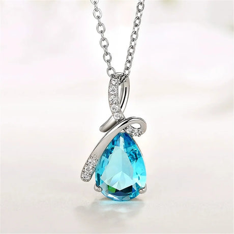 Blue teardrop pendant necklace on a white background